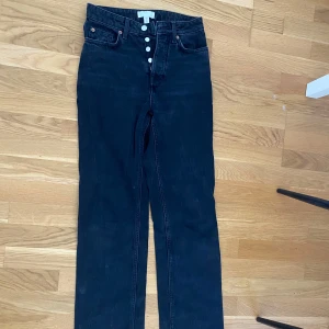 Svarta jeansbyxor - Snygga svarta jeansbyxor i en klassisk stil. De har en normal passform och är perfekta för en avslappnad look. Byxorna har en knapp och dragkedja framtill.