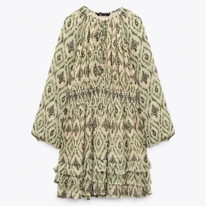 Grönmönstrad klänning från Zara - Klänning från Zara med grönt och beige mönster,💚Knappt använd därav mycket bra skick! Klänningen har v-ringning med knappar framtill och volangdetaljer nertill. Perfekt för vår och sommar! Tryck på KÖP NU så postar jag inom 1 dag!