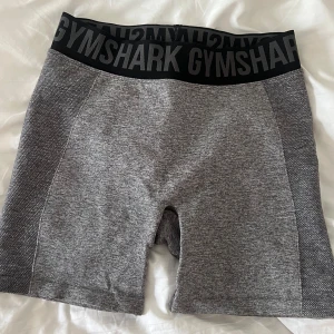 Grå träningshorts från Gymshark - Snygga grå shorts från Gymshark. Tight passform och hög midja 🩷storlek M men passar även S.