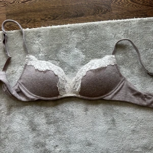 Intimissimi bh - Superfin ljuslila bh med ribbad yta och vita spetsdetaljer längs kuporna. Justerbara axelband och mjuk känsla, perfekt för dig som gillar en feminin och bekväm stil. Kuporna är lätt vadderade och ger snygg form.