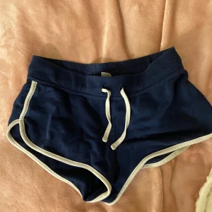 Korta mjukis shorts - Ett par korta mörkblåa mjukis shorts. Man kan vika ned dom så att de blir mer lågmidjade.