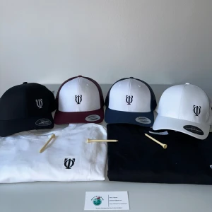 Kepsar med broderad logotyp - Snygga kepsar i olika färger med broderad logotyp framtill. Finns i svart, vit, vinröd och marinblå. Kepsarna har en klassisk design med justerbar snapback-stängning för perfekt passform.