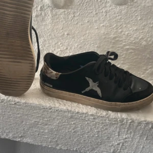 Svarta sneakers med broderad fågel - Axel arogato skor med leopard mäster 