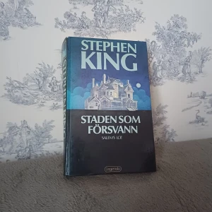Staden som försvann - Säljer boken 'Staden som försvann' av Stephen King, utgiven av Legenda. En spännande skräckroman som utspelar sig i Jerusalem's Lot, Maine. Perfekt för dig som älskar rysare och mystik. Omslag av Olle Franzén.