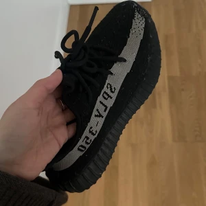 Svarta Adidas Yeezy sneakers - Säljer ett par Adidas Yeezy Boost 350 V2 ‘Oreo’. Inga defekter förutom det som visas på bilden, dock inget som syns eller känns. Storlek 37🌸