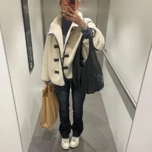 Vit teddyjacka med svarta detaljer - Säljer en mysig vit teddyjacka! Bra skick och jag köpte den här på plick för 800 kr💓