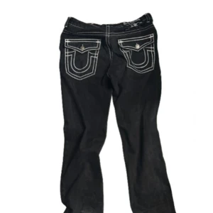 Svart True Religion jeans - Svarta jeans från True Religion me vita sömmar lite heelbite men annars bra kvalité. Pris kan diskuteras vid snabb affär.