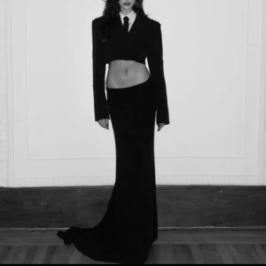 Svart croppad kavaj från Zara - Säljer en svart croppad kavaj från Zara med klassisk krage och knapp framtill. Kavajen har lång ärm och en stilren, minimalistisk look som ger en edgy vibe. Perfekt att styla med både kjol och jeans för en trendig outfit.