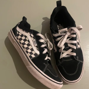 Vans rutiga sneakers - Svart-vita Vans. Skorna har vit sula, vita snören och detaljer i mocka och canvas. Fina skick, sulorna ej slitna! Storlek 38/24 cm.