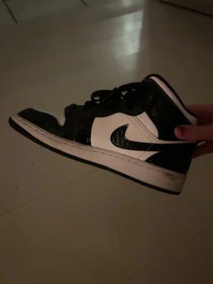 Air Jordan skor - Nästan helt oanvändna Air Jordan 1 skor med svart och vit detaljer. Köptes för kanske 5 år sedan och inte används sedan dess! Finns lite spår p användning, finns på första bild. (Pris kan diskuteras)
