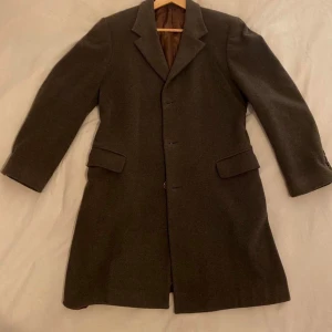 100% cashmere rock från Wool and Cashmere - 100 % kashmirrock från Wool and Cashmere, inköpt i Italien. Storlek 48. Skräddarsydd hos Jens Dahlström i Stockholm, vilket ger den en något slim fit-passform. Ett hål har blivit professionellt lagat (se bild). Vissa tecken på användning eftersom den har burits flitigt.