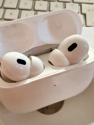 Apple AirPods Pro 2 MagSafe Charging Case USB-C 2023 A3048 - AirPods Pro 2 MagSafe Charging Case USB-C trådlösa hörlurar i färgen vit. Hörlurarna levereras med ett laddningsfodral och USB-C laddningskabel. De har aktiv brusreducering och anpassningsbara silikonproppar för bättre passform.  • Modell: A3048 • Modell år: 2023 • Haft fodral sedan dag 1 • Kvitto finns såklart, inköpt november 2023 • Uppdaterad med senaste mjukvara: 8B28 • Komplett med allt som ingick vid nyköp såsom Originalförpackning, Laddningskabel, Extra öronpluggar (oanvända) & Fodral 