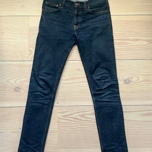 Nudie Jeans Raw Denim - Tjena! Riktigt stilig raw denim från Nudie Jeans. Raw/dry denim innebär att de förändras med tiden så de blir snyggare ju mer du bär dem. Använda endast ett fåtal gånger och aldrig tvättade. Storlek 33/36. 99% bomull, 1% elastan. Pris kan självklart diskuteras!