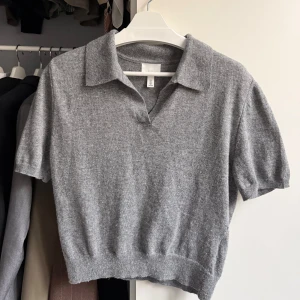 Grå stickad polotopp - 🤍Grå stickad polotopp från H&M med korta ärmar och klassisk krage. Toppen har en croppad passform 🤍