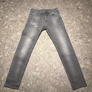 7 FOR ALL MANKIND  - 7 FOR ALL MANKIND jeans med slitningar. Ljus grå färg med rött tyg i fickorna. 