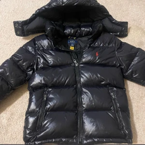 Svart pufferjacka från Polo Ralph Lauren - Säljer en svart pufferjacka från Ralph L, köpte den på Vinted för 2 månader sedan men passade tyvärr inte killen. Den är i jätte fint skick inga märken  