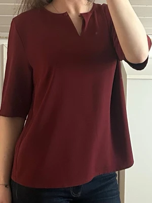 Vinröd blus  - Superfin vinröd blus från Carin Wester. Använd sparsamt och har inga anmärkningar. Kan ha med uppknäppt knapp eller stängd. 