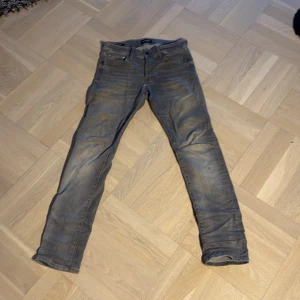 Grå slim jeans från Jack & Jones - Slim Glenn jeans från Jack & Jones i en grå färg, passform är slim fit klassisk femficksdesign och normal midja. Tillverkade i mjukt denimtyg med stretch för extra komfort. Perfekta för dig som gillar en stilren och modern look. Liten defekt man ser på sista bilden som syns inte när man har på sig de. Pris kan diskuteras 🤗