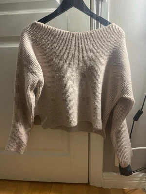 Beige ribbad stickad tröja Even&Odd - Mysig beige stickad tröja från Even&Odd med ribbad struktur och avslappnad passform. Tröjan har långa ärmar och en något croppad modell som ger en modern vibe. Perfekt för lager på lager under höst och vinter.