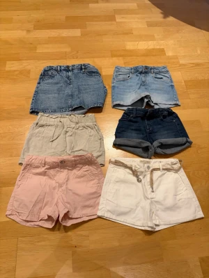 Shorts och kjol set, 6st - Ett set med sex par shorts och en kjol. Innehåller shorts i olika färger som rosa, beige, vita och blå denimshorts. Kjolen är i blå denim.  Märken: Zara Girls, Polarn o Pyret, Lindex  Storlek: 8-10år