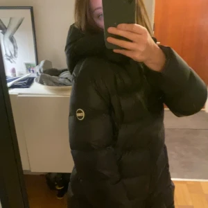 Svart lång dunjacka från Colmar i bra skick!! - Säljer en svart lång dunjacka från Colmar i mycket bra skick. Jackan har en normal passform och är supervarm och mysig. Den är använd Ändast fåtal gånger och i väldigt bra skick💞