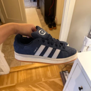Adidas Campus mörkblå nyskick - Säljer ett par Adidas Campus i den mörkblå färgen. Storlek 37 1/3. Använda max 3-4 gånger. Har vanligtvis storlek 37/38 o dessa är mer åt 37 hållet. Nypris 1449kr från Nellys hemsida