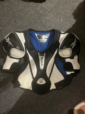 Axelskydd hockey - Axelskydd från Reebok i mycket bra skick! Storlek 146-158!