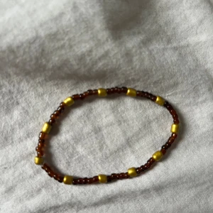 Armband - Brunt guldigt