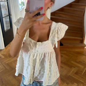 Vit blus med volangärmar och knappar - Supersöt vit blus med volangärmar och knappar framtill! Från asos i storlek 36