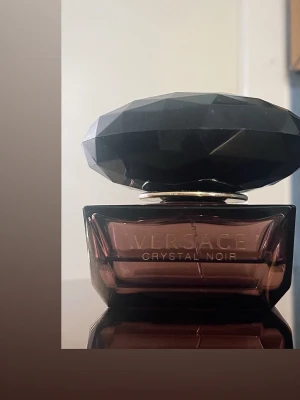 Versace Crystal Noir EdT 50ml - Versace Crystal Noir Eau de Toilette, 50ml, tillverkad i Italien. En ikonisk doft i en elegant flaska som ger exklusiv känsla till din samling. Perfekt för dig som vill sticka ut med stil.