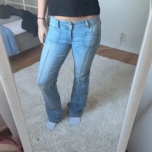 Blå bootcut jeans från Madlady - Säljer ett par ljusblå bootcut jeans från Madlady i storlek 36/short. Jeansen är mid waist, stora framfickor och bakfickor med knappdetalj💗