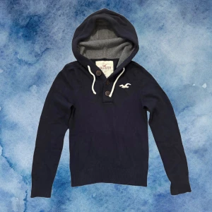 Stickad Hollister Hoodie - Säljder denna riktigt deta stickade Hollister Hoodien med knappar vid kragen! | Storlek S| Modell 175cm och 72 kg | Riktigt Fint skick (förutom att hoodien overall är nopprig men syns ej men kan såklart tas bort)  | Längd ≈ 60cm , bredd armhåla -armhåla ≈ 43cm 