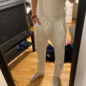 Vita linnebyxor med snörning - Säljer ett par vita linnebyxor från Skagen clothing med anpassbar snöre i midjan. De är stilrena och gjorda i svalt linne tyg vilket gör det perfekt för värmen. De är i väldigt bra skick. Är i xs men passar S!