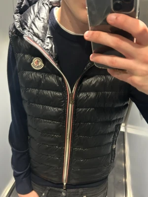 Moncler väst - Säljer denna moncler väst med luva | Väldigt bra skick | Storlek 2, motsvarar ca S/M | Sällsynt modell, säljs ej längre | Självklart äkta | priset är diskuterbart vid snabbaffär!