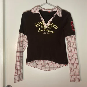 Esprit långärmad kort tröja med insydd skjorta - En brun tröja från Esprit med inbyggda skjortärmar och krage. Storlek S, sitter slappt men är kortare i magen