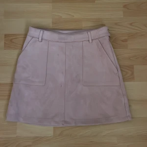 Rosa tajt minikjol kjol från Lindex - Snygg tajt rosa kjol från Lindex i storlek XS. Kjolen har en stilren design med fickor framtill och hällor för bälte. Perfekt för en festlig look!Priset kan diskuteras.🫶