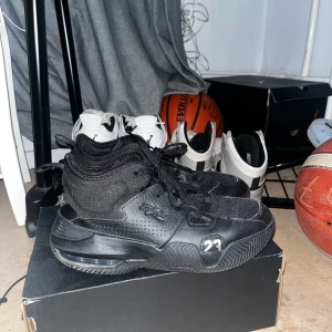 Svarta Nike Jordan basket skor - Säljer ett par svarta Nike  Jordans i bra skick. De har en cool design med nummer 23 på sidan och är perfekta för både vardag och sport. Skorna har snörning och är gjorda i syntetmaterial för hållbarhet och stil.