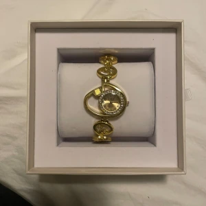 Antik guldklocka - Elegant guldfärgad armbandsklocka med en unik design. I rostfritt stål och vattentät. Har försökt söka upp märket men verkar vara nått antikt som inte finns att köpa längre, finns endast på auktioner. Batteriet behöver bytas. Inga skavanker i övrigt