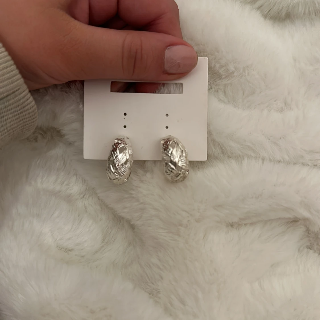 Silverfärgade örhängen med mönster