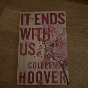 It Ends With Us - Säljer boken 'It Ends With Us' av Colleen Hoover. Omslaget är ljust med rosa blommor och stora röda bokstäver. Boken handlar om kärlek och svåra relationer, och är känd för att vara både gripande och hjärtskärande. Perfekt för dig som gillar emotionella romaner.