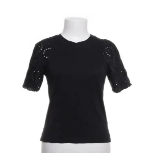 Svart topp från H&M - Snygg svart topp från H&M med kortärmade spetsdetaljer. Perfekt för en stilren look. Tillverkad i ett mjukt material som ger en bekväm passform.