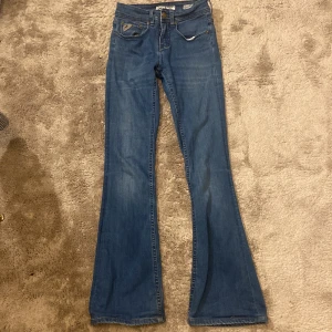 Blå bootcut jeans från Lois - Snygga blå bootcut jeans från Lois med klassisk femficksdesign och logotypdetaljer på bakfickan.Tillverkade i ett bekvämt denimtyg💕Storlek L32🫶Bra skick🥰