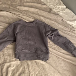 Grå sweatshirt från Pull&Bear - Säljer en stilren grå sweatshirt från Pull&Bear i storlek XS. Tröjan har långa ärmar och ribbade muddar vid ärmslut och nederkant. Perfekt för en avslappnad look.