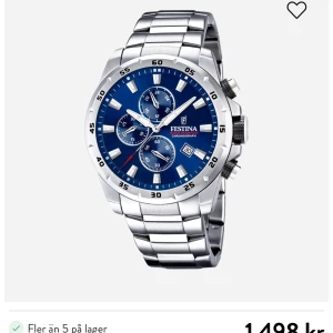 Silverfärgad klocka från Festina - Snygg och stilren klocka från Festina med en blå urtavla och silverfärgad länk. Klockan har flera små urtavlor och en datumvisare, vilket ger den en sportig och modern look. Perfekt för den som vill ha en kombination av funktion och stil.