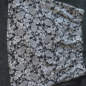 Kjol med dragkedja baktill  - En svart kjol med mönster och dragkedja baktill. Aldrig använt den så den är som ny