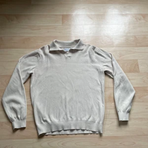 Beige tröja från These Glory Days - Säljer en stilren beige tröja från These Glory Days i storlek S. Tröjan har en klassisk krage och långa ärmar, perfekt för en avslappnad look. Den är tillverkad i ett mjukt material som ger en bekväm passform.