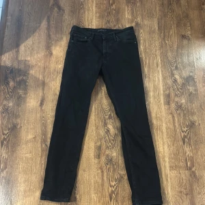 Svarta jeansbyxor - Snygga svarta jeansbyxor med en klassisk femficksdesign. De har en slim passform och är perfekta för en stilren look. Byxorna har en dragkedja och knapp framtill.