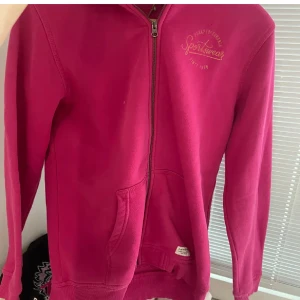 Rosa hoodie med dragkedja - Säljer en snygg rosa hoodie från Team Everest med dragkedja framtill. Perfekt för en avslappnad stil. Den har långa ärmar och en bekväm passform.