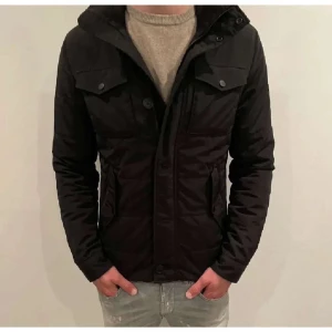 Svart jacka från J.Lindeberg -  J.Lindberg bailey: 4000kr nypris säljes för 1599 finns inga defekter på jackan förutom att dragkedjan inte funkar men det är lätt att laga.         Därav det låga priset🙌🏻