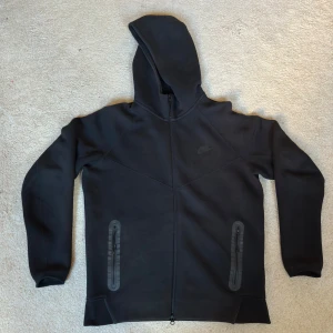 Nike Tech Fleece Hoodie Zip - Säljer en svart Nike tech fleece zip storlek L Perfekt skick, inga defekter. Säljer för att den är för stor. Finns inte längre tillgänglig på Nike. De har gjort en ny version. Skriv gärna om ni har några frågor!